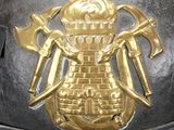a close up of a helmet with a gold emblem on it