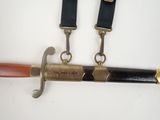 a knife and a knife holder hanging on a wall