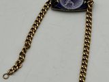 a close up of a chain with a coin on it
