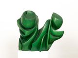 sculpture of a green sculpture on a white pedestal against a white background