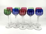 six verres à vin sont alignés sur une surface blanche