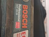 a close up of a bosch power tool on a table