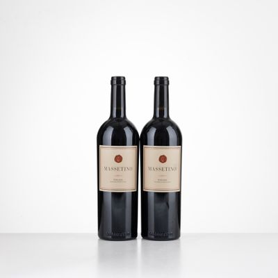 two bottles of red wine sitting on top of a table