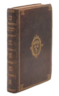 an old book with a gold emblem on the cover
