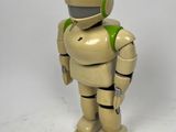 a toy robot that is standing on a white surface