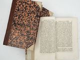 an open book sitting on top of a table next to an open book