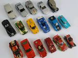 several toy cars are lined up in a row on a white surface