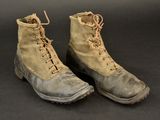 an old pair of military boots on a black surface