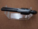 a gun that is sitting on top of a clear box