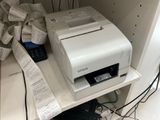a printer sitting on top of a shelf next to a calculator