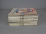 several comics stacked on top of each other on a table
