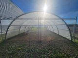 the sun shines brightly on the inside of a large greenhouse