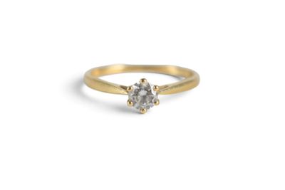 an image of a gold ring with a white diamond