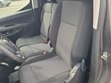 the interior of a small van with two seats and a steering wheel