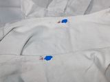 a close up of a pair of white pants with blue patches on them