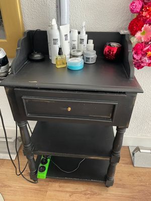 a black table with a lot of beauty products on it