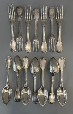 a lot of silver spoons and forks on the table