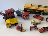 a lot of toy cars and trucks on a white surface