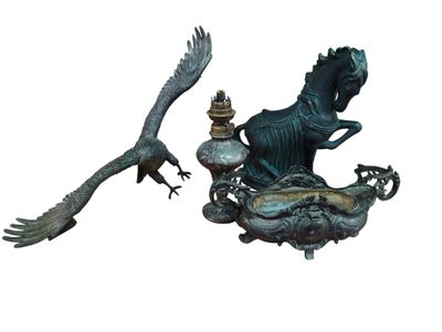 a statue of a woman riding a horse next to a statue of a bird