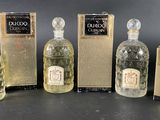 six bottles of liquor are lined up in a row on a table