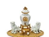 a figurine of three cats sitting on a table