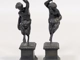pair of antique bronze figurines of a man and a woman