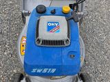 a blue lawn mower that is sitting on the ground