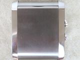 a silver metal cigarette case sitting on the floor