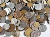 a pile of coins sitting on a white surface