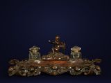 a statue of a man sitting on top of a table