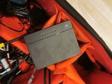 an open suitcase with a laptop and other electronics in it