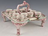 a tray with cups and saucers on top of it