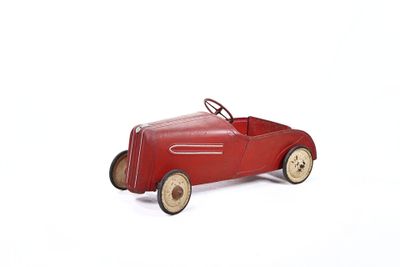 a red toy car sitting on a white surface