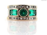 an image of a ring with emeralds and diamonds