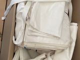a cardboard box full of white cloths in it
