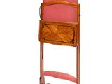 a wooden chair with a pink cushion on it