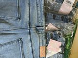 a pair of jeans in a plastic bag on a table