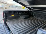 a black truck with a flat bed in the back of it