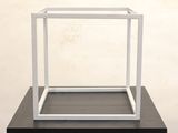 an image of a small white box on a black table