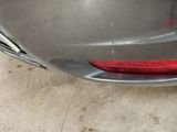 a close up of a car ' s tail light and bumper