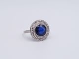 a blue sapphire and diamond ring on a white background