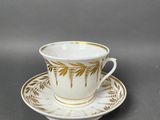 a close up of a cup and saucer on a table