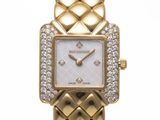 a close up of a gold wrist watch with diamonds on it