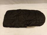 sleeping bag on a bed with white sheets and white sheets