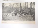 a black and white photo of a group of people and dogs