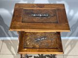 two wooden tables that have carvings on them