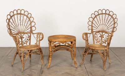 two chairs and a table in a room with a white wall