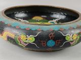 a black bowl with a dragon design on it