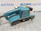 a blue electric sander sitting on top of a table