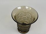 a glass vase with a pattern on it on a white surface